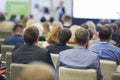 Professional Female Host Speaking in Front of the Large Audience During Business Conference