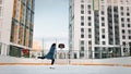 Professional female ice figure skater practicing spinning on outdoor skating rink. Video. Woman ice dancing surrounded