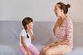 Professional female language therapist working on speech defects with child girl kid having language lesson for improving speaking Royalty Free Stock Photo