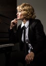 Professional female musician sitting near piano Royalty Free Stock Photo