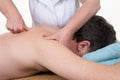 Professional female physiotherapist giving shoulder massage at hospital Royalty Free Stock Photo