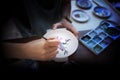 Professional female potter examining paint ceramic  with handle in workshop, studio. Handmade, small business, crafting work Royalty Free Stock Photo