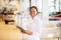 Professional female salesperson working in car dealership