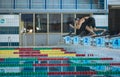 Female swimmer jumping into a pool from the starting block Royalty Free Stock Photo