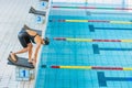 Female swimmer preparing and jumping off the starting block Royalty Free Stock Photo