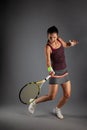 Professional female tennis player. Girl swinging racket Royalty Free Stock Photo