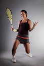 Professional female tennis player. Happy girl screaming with racket in hands Royalty Free Stock Photo