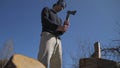 Professional firewood chopper. A lumberjack works outdoors. A man stands in front of a stack of firewood with an axe in his hands Royalty Free Stock Photo