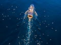 professional fisherboat with many seagulls come back in the harbor. Aerial view, drone