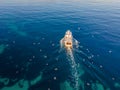 professional fisherboat with many seagulls come back in the harbor. Aerial view, drone