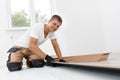 Professional flooring installation - laying a new laminate with a wooden pattern Royalty Free Stock Photo