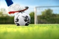 Professional football or soccer player kick and shoot ball at penalty or freekick to goalkeeper for winning champion goal in final Royalty Free Stock Photo