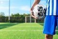 Professional football or soccer player kick and shoot ball at penalty or freekick to goalkeeper for winning champion goal in final Royalty Free Stock Photo