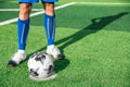 Professional football or soccer player kick and shoot ball at penalty or freekick to goalkeeper for winning champion goal in final Royalty Free Stock Photo