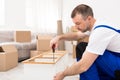 Professional Furniture Assembler Man Fixing And Assembling Wooden Shelf Indoors Royalty Free Stock Photo
