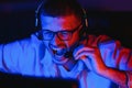 Professional Gamer Plays Video Game on His Computer. He`s Participating in Online Cyber Games Tournament or in Internet Cafe. He Royalty Free Stock Photo