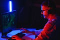 Professional Gamer Plays Video Game on His Computer. He`s Participating in Online Cyber Games Tournament or in Internet Cafe. He Royalty Free Stock Photo