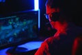 Professional Gamer Plays Video Game on His Computer. He`s Participating in Online Cyber Games Tournament or in Internet Cafe. He Royalty Free Stock Photo