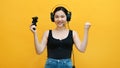 Professional gamer, young asian girl with headset and joystick winning video game