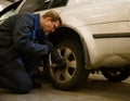 Professional garage mechanic repair the leaky tire car wheels. Car engineer technician changing a car tire on a vehicle. Concept