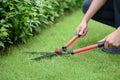 Professional Gardener Trimming Lawn In The Garden Royalty Free Stock Photo