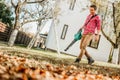 Professional gardener using leaf blower and working in garden