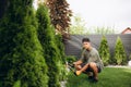 Professional Gardener at Work. Gardener Trimming Garden Plants. Topiary Art. Royalty Free Stock Photo