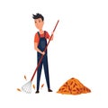 Professional gardener working on backyard acollects fallen leaves with a rake. Male handyman making autumn cleaning in