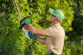 Gardener Using Hedge Trimmer