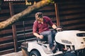 Professional gardner riding lawn mower - landscaping and gardening details Royalty Free Stock Photo