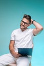 Professional general physician, smiling trustworthy friendly young man in glasses, medical uniform on blue background Royalty Free Stock Photo