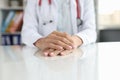 Professional general practitioner or cardiologist sits at table