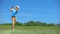 Professional golf player hitting swing shot at course, training before game Royalty Free Stock Photo