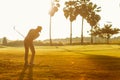 Professional Golfer asian man swing and hitting golf ball practice at golf driving range and fairway in sunny morning day on club Royalty Free Stock Photo