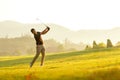 Professional Golfer asian man swing and hitting golf ball practice at golf driving range and fairway in sunny morning day on club Royalty Free Stock Photo