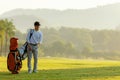 Professional Golfer asian man walking in fairway with bag golf with club. Hobby in holiday and vacation with friends.