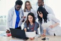 Group of young multi national doctors during working with laptop in the conference room. Royalty Free Stock Photo