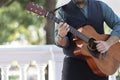 Professional guitarist plays guitar outdoors