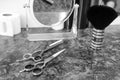 Professional hair cutting scissors, hair brush, paper collars and a mirror in a hairdressing salon Royalty Free Stock Photo