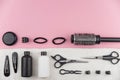 Professional hair dresser tools with copy space. Hair stylist equipment set on pink background. Royalty Free Stock Photo