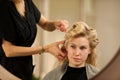 Professional hair stylist at work - hairdresser doing hairstyle Royalty Free Stock Photo