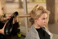 Professional hair stylist at work - hairdresser doing hairstyle Royalty Free Stock Photo