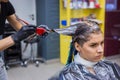 Professional hairdresser coloring hair of woman client at studio Royalty Free Stock Photo