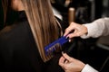 Professional hairdresser is combing the wet hair of the female client. Close-up Royalty Free Stock Photo