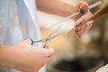 Professional hairdresser cutting hair of her client