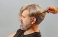 Professional hairdresser make hair cut. Barber concept. Male client getting haircut by hairdresser. Close up portrait. Royalty Free Stock Photo