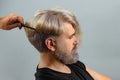 Professional hairdresser make hair cut. Barber concept. Male client getting haircut by hairdresser. Close up portrait. Royalty Free Stock Photo