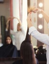 Hairdresser trimming long brown hair with scissors Royalty Free Stock Photo