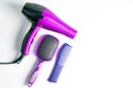 Professional hairdresser's set on white background, top view. Hairdryer, hair brushes, combs Royalty Free Stock Photo