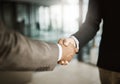 A professional handshake after an interview meeting for a company in a modern corporate office. Formal executive